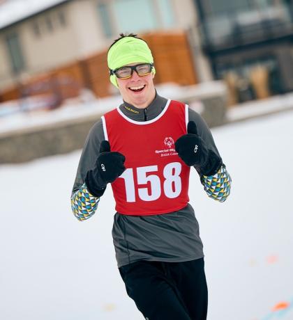 Torben smiling with thumbs up wearing his snowshoeing gear