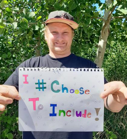 SOBC Comox Valley athlete holding #IChooseToInclude sign