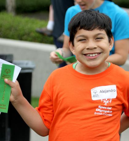 SOBC young athlete smiling holding a ribbon