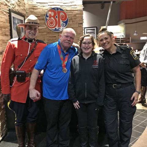 SOBC athlete with law enforcement members at Boston Pizza