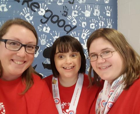 Charity Sheehan poses for a photo with two SO athletes