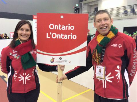 SOO's Juli Prokopchuk-Brattan and athlete Stephen Graham hold a sign that reads Ontario.