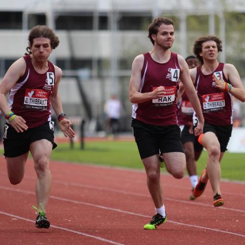 Athletes racing intensely on the track