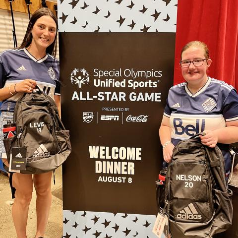 Maya and Amy receiving their team bags