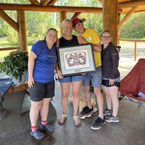 Gale Jones holding award with fellow athletes