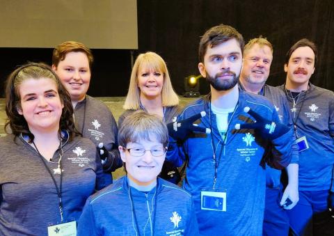 SOBC - Oceanside athletes and coaches standing together indoors with smiles on their faces