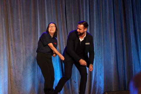 SOBC athlete and Canucks alumnus Chris Higgins doing a hockey pose on stage