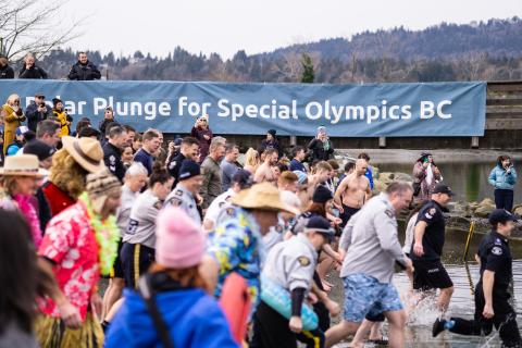 Polar Plungers in their costumes running excitedly into the water