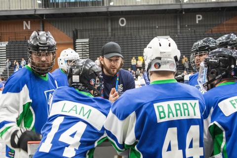 Brendan giving the floor hockey team words of encouragement during a team huddle at National Games!