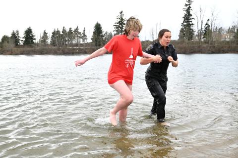 SOBC athlete and law enforcement member running through cold waters