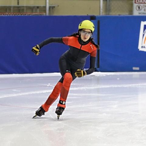 Hillary speed skating on the ice