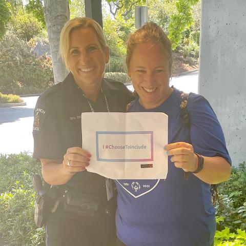 Lisa and Sheenagh holding a sign saying "I #ChooseToInclude"