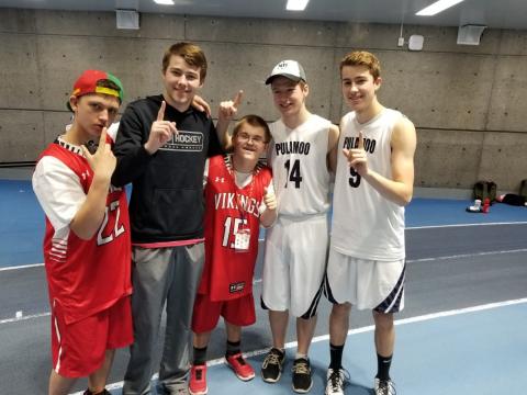 Logan smiles at the camera with his basketball team at the Youth Invitational Games in Toronto