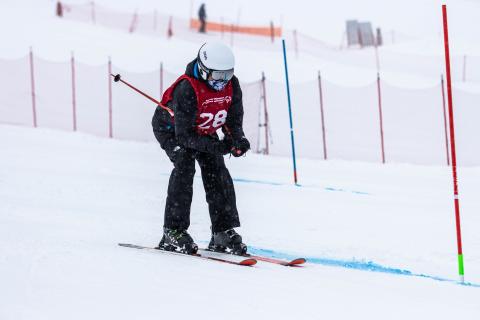 Ron skiing down rapidly in the snow