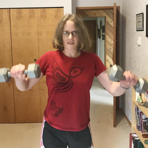 Miranda lifting dumbells in both hands