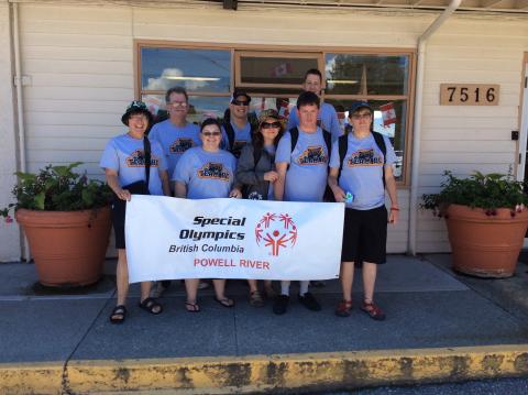 Special Olympics - Powell River Team BC posing for a photo with their Local banner