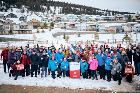 Group photo of SOBC snowshoe athletes and coaches, with each holding Tim Hortons Special Olympics Donut