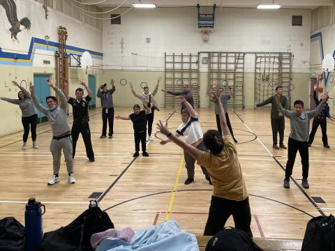 Club Fit athletes raising hands, following the instructor