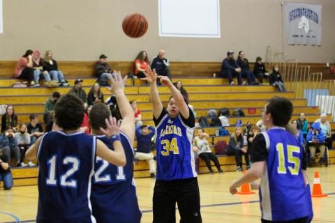 SOBC athlete shooting a basketball with others contesting his shot
