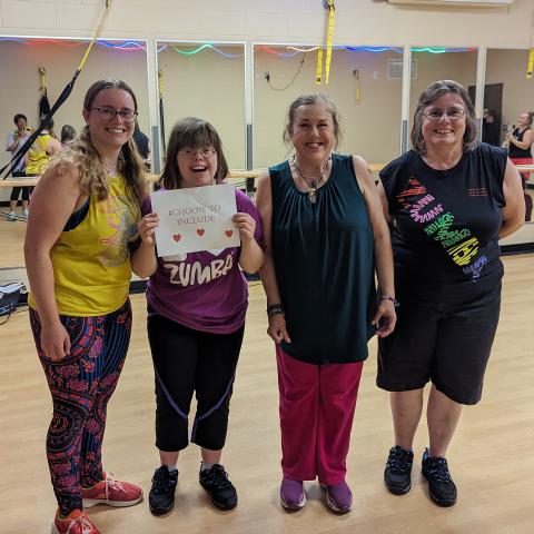 Claire and three other Zumba class participants smile