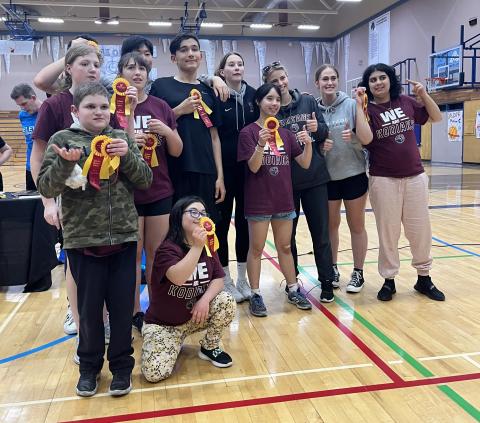 Student-athletes celebrating inclusion and achievements at Mark R. Isfeld Secondary holding up their ribbons