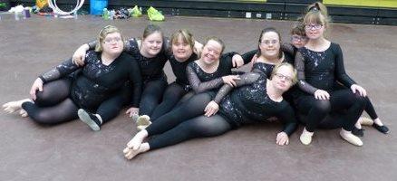 SOBC – Kelowna rhythmic gymnastics athletes sitting on floor posing for group photo
