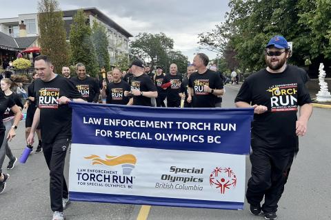 LETR participants running and smiling, holding LETR banner