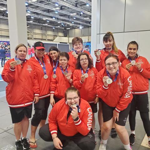 Special Olympics Team Canada women's basketball team celebrating their silver medals