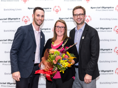 Special O PEI ED Charity Sheehan poses for a photo holding flowers at an event.