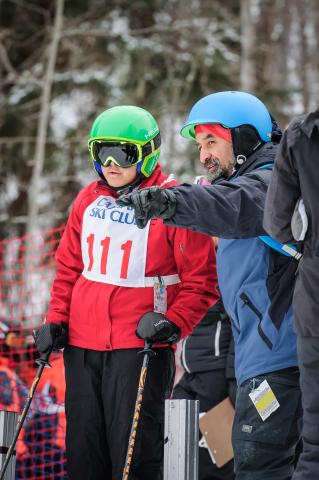 Martin McSween points at something while he coaches an athlete.