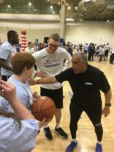 Sean Annan smiling as he is coaching other athletes with intellectual disabilities