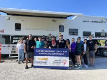 Delta PD members with SOBC athletes and participants holding LETR banner