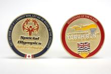 Photo of two BC LETR challenge coins