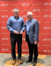 Safeway representative holding award with Dan Howe