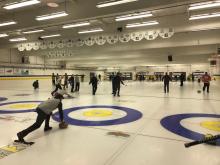 View of curling rink with curlers in action